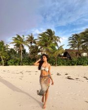 Breathtaking Actress Malavika Mohanan in a White Bikini Top and Floral Beach Sarong Photos 03