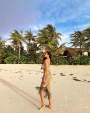 Breathtaking Actress Malavika Mohanan in a White Bikini Top and Floral Beach Sarong Photos 05