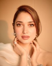 Breathtaking Tamannaah Bhatia in a Ruffled One Shoulder White Top with Ripped Denim Jeans Photos 01