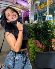 Breezy Actress Rashmika Mandanna in a Black Crop T Shirt Grey Acid Wash Jeans Photos 02
