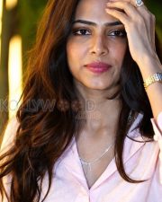 Charming Actress Malavika Mohanan in a Pale Pink Sheer Shirt White Trousers Photos 03