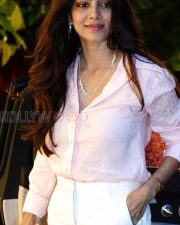 Charming Actress Malavika Mohanan in a Pale Pink Sheer Shirt White Trousers Photos 04