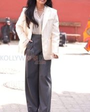 Chic Actress Rashmika Mandanna in a Cream Blazer and Grey Wide Leg Trousers Photos 05