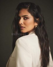 Classy Malavika Mohanan in an Off White Long Coat and Thigh Slit Skirt Photos 01