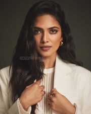 Classy Malavika Mohanan in an Off White Long Coat and Thigh Slit Skirt Photos 04