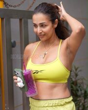Confident Actress Malaika Arora in a Yellow Reebok Sports Bra and Shorts Photos 01