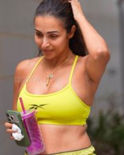 Confident Actress Malaika Arora in a Yellow Reebok Sports Bra and Shorts Photos 02