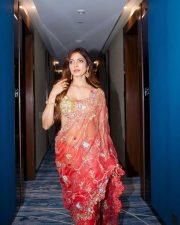 Desi Glamour Malavika Mohanan in a Sheer Coral Orange Saree with Floral Embroidery with a Gold Shimmer Blouse Photos 03