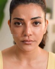 Elegant Kajal Aggarwal in a Yellow Buttoned Up Sleeveless Top and Blue Denim Pants Photos 02