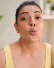 Elegant Kajal Aggarwal in a Yellow Buttoned Up Sleeveless Top and Blue Denim Pants Photos 03