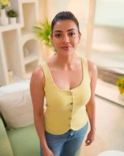 Elegant Kajal Aggarwal in a Yellow Buttoned Up Sleeveless Top and Blue Denim Pants Photos 04