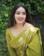 Enchanting Actress Malavika Menon in a Olive Gold Silk Saree Photos 01