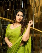 Enchanting Actress Malavika Menon in a Olive Green Silk Saree Photos 05