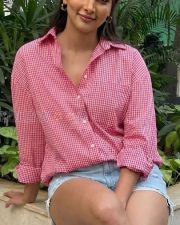 Fashionable Actress Pooja Hegde in a Pink Gingham Shirt And Denim Shorts Photos 01