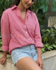 Fashionable Actress Pooja Hegde in a Pink Gingham Shirt And Denim Shorts Photos 02