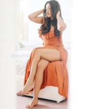 Glamorous Catherine Tresa in an Orange High Slit Bodycon Dress showcasing her Toned Thighs Photos 03