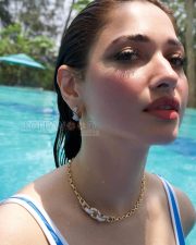 Glowing Actress Tamanna Bhatia in a Blue and White Swimsuit Photos 01