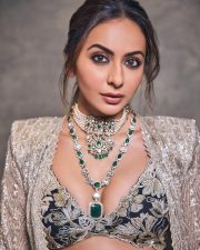 Gorgeous Indian Actress Rakul Preet in a Margot Floor Length Open Front Champagne Gold Long Jacket with a Plunging Neckline Bralette and Black Flared Skirt Pictures 06