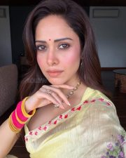 Graceful Actress Nushratt Bharucha in a Yellow Floral Embroidered Saree Photos 04