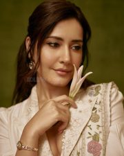 Graceful Raashi Khanna in an Ivory Linen Saree with Floral Embroidery with Puff Sleeve Blouse Photos 04