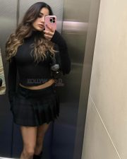 Grunge Beauty Janhvi Kapoor in a Fitted Black Turtleneck with Long Sleeves with Matching Black Pleated Mini Skirt Photos 02