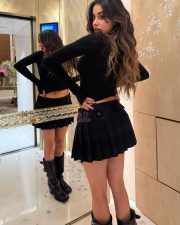 Grunge Beauty Janhvi Kapoor in a Fitted Black Turtleneck with Long Sleeves with Matching Black Pleated Mini Skirt Photos 03