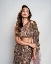 Hot Bollywood Dancer Malaika Arora in a Gold Embellished Lehenga with an One Shoulder Cutout Blouse and Long Skirt Pictures 02