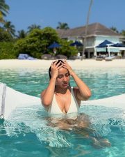 Hot Glam Neha Sharma in a White Cleavage Swimsuit at Maldives Photos 01