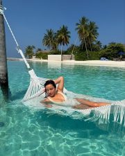 Hot Glam Neha Sharma in a White Cleavage Swimsuit at Maldives Photos 02