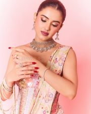 Hot Malvika Sharma in a Pastel Pink Sequined Embroidered Corset Top with Floral Embellishments and Pre Draped Saree Pictures 09