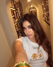 Hot and Sexy Janhvi Kapoor in a White Crop Top and Orange Mini Skirt Photos 01