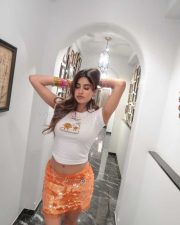 Hot and Sexy Janhvi Kapoor in a White Crop Top and Orange Mini Skirt Photos 03