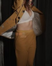 Mookuthi Amman 2 Actress Regina Cassandra in a Mango Yellow Embroidered Blazer with Matching Mustard Yellow Straight Leg Pants and White V Neck Bralette Photos 01