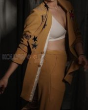 Mookuthi Amman 2 Actress Regina Cassandra in a Mango Yellow Embroidered Blazer with Matching Mustard Yellow Straight Leg Pants and White V Neck Bralette Photos 02