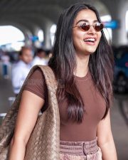 Photogenic Actress Pooja Hegde in a Brown Tee at Airport Photos 02
