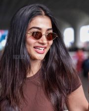 Photogenic Actress Pooja Hegde in a Brown Tee at Airport Photos 04
