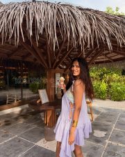 Playful Actress Malavika Mohanan in a Lavender Tie Shoulder Ruffle Mini Dress Photos 02