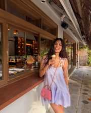 Playful Actress Malavika Mohanan in a Lavender Tie Shoulder Ruffle Mini Dress Photos 04