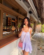 Playful Actress Malavika Mohanan in a Lavender Tie Shoulder Ruffle Mini Dress Photos 05