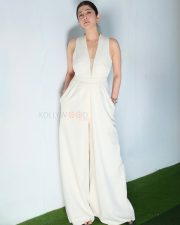 Poised Actress Pranita Subhash in a White V Neck Sleeveless Jumpsuit Photos 02