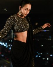 Poison Baby Actress Malaika Arora in a Full Sleeved Cropped Embellished Sequinned Blouse with a Classic Black Saree Photos 02