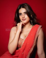 Radiant Actress Nidhhi Agerwal in a Red Orange Georgette Saree Photos 03