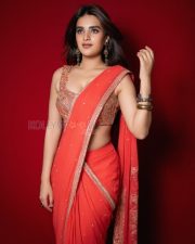 Radiant Actress Nidhhi Agerwal in a Red Orange Georgette Saree Photos 07