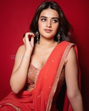 Radiant Actress Nidhhi Agerwal in a Red Orange Georgette Saree Photos 10