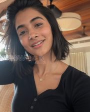 Radiant Actress Pooja Hegde in a Black ribbed henley top Photos 02