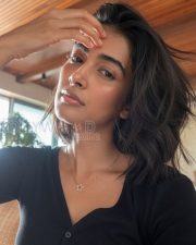 Radiant Actress Pooja Hegde in a Black ribbed henley top Photos 04