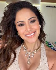 Radiant Nushrratt Bharuccha Cleavage in a White Embroidered Mirror Work Lehenga Blouse Photos 01