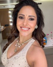 Radiant Nushrratt Bharuccha Cleavage in a White Embroidered Mirror Work Lehenga Blouse Photos 02