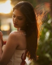 Ravishing Heroine Malavika Mohanan in an Ivory and Red Chiffon Bandhani Printed Maxi Dress Pictures 04