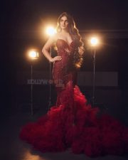 Ravishing Nidhhi Agerwal in a Sequined Red Strapless Gown with Deep Neck Cleavage Photos 02